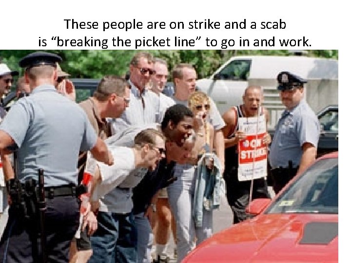 These people are on strike and a scab is “breaking the picket line” to