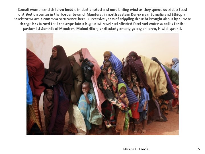 Somali women and children huddle in dust-choked and unrelenting wind as they queue outside