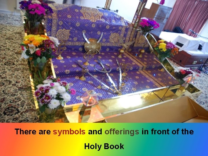 There are symbols and offerings in front of the Holy Book 