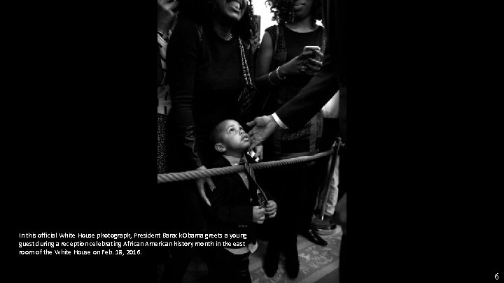 In this official White House photograph, President Barack Obama greets a young guest during