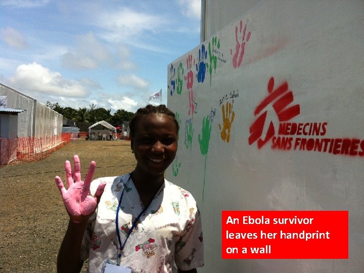 An Ebola survivor leaves her handprint on a wall 