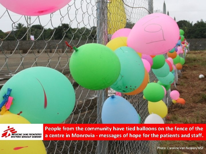 People from the community have tied balloons on the fence of the a centre