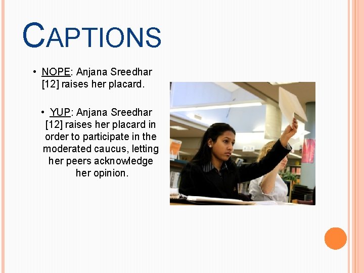 CAPTIONS • NOPE: Anjana Sreedhar [12] raises her placard. • YUP: Anjana Sreedhar [12]