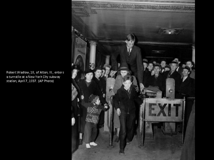 Robert Wadlow, 18, of Alton, Ill. , enters a turnstile at a New York