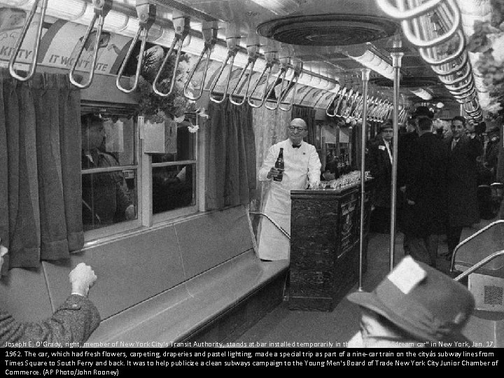Joseph E. O'Grady, right, member of New York City's Transit Authority, stands at bar