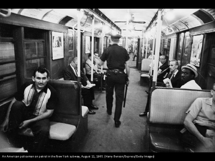 An American policeman on patrol in the New York subway, August 11, 1965. (Harry