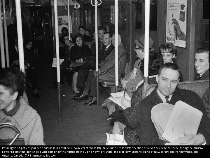 Passengers sit patiently in near-darkness in a stalled subway car at West 4 th