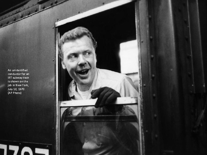 An unidentified conductor for an IRT subway train is shown on the job in