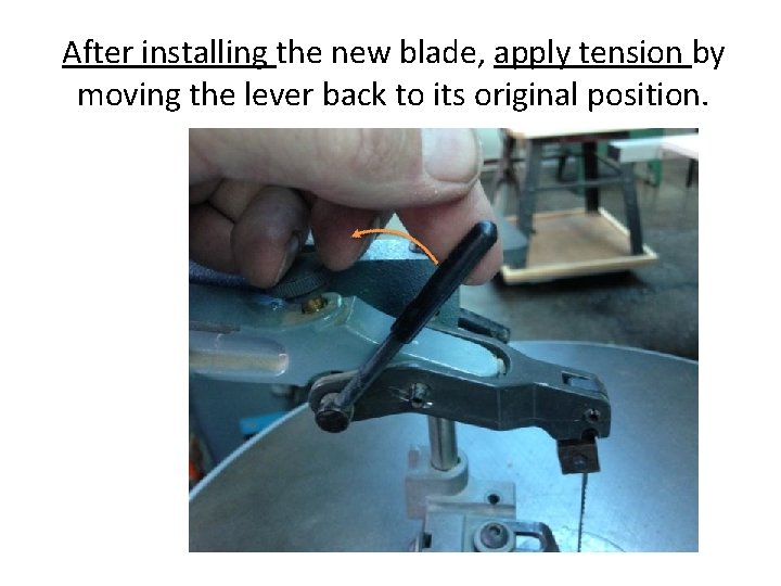 After installing the new blade, apply tension by moving the lever back to its