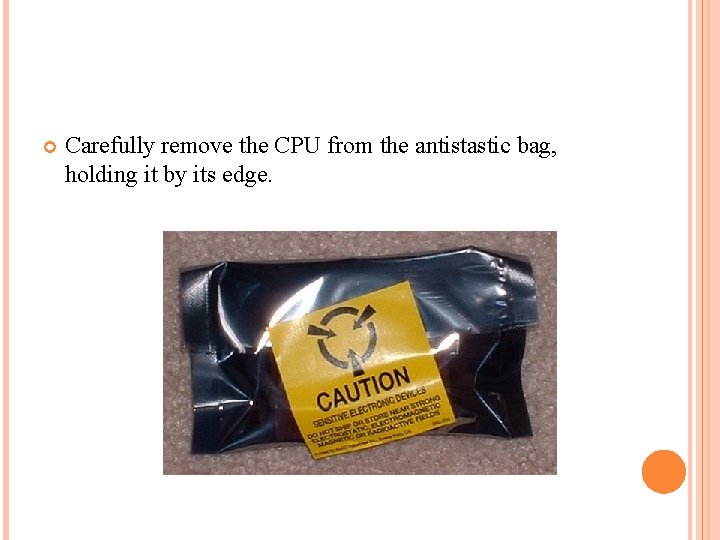  Carefully remove the CPU from the antistastic bag, holding it by its edge.
