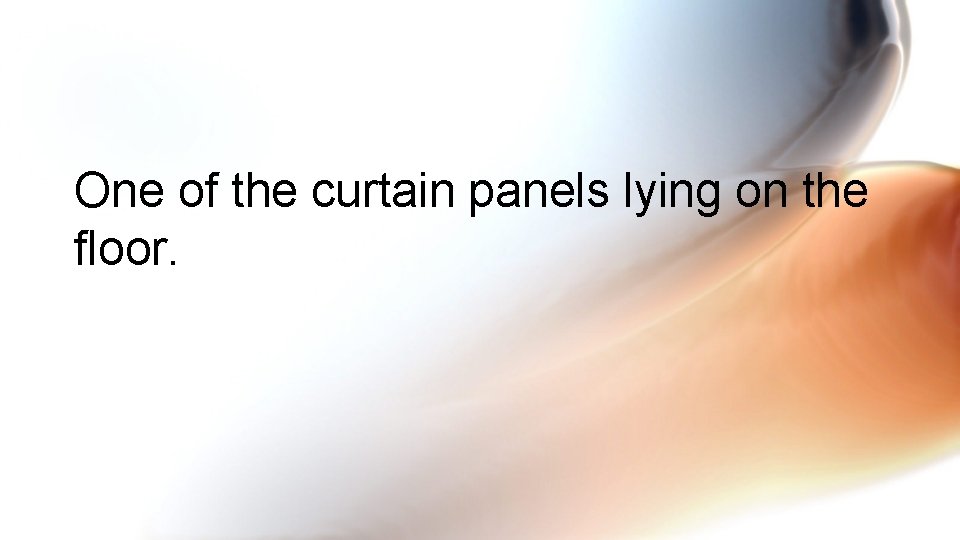 One of the curtain panels lying on the floor. 