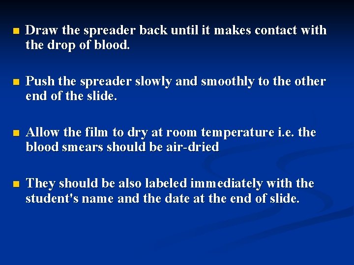 n Draw the spreader back until it makes contact with the drop of blood.