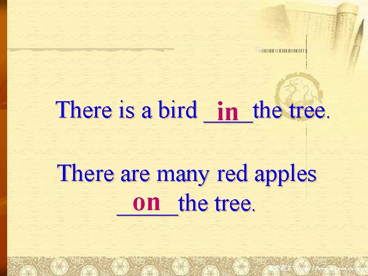 There is a bird ____the tree. in There are many red apples on _____the