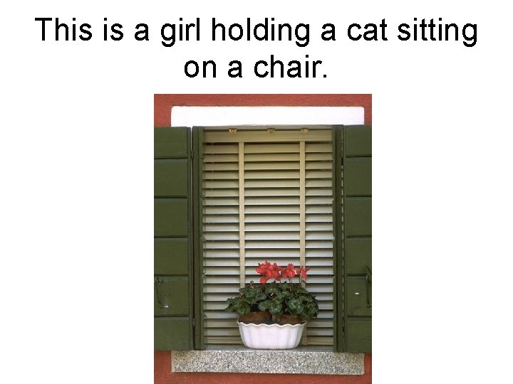 This is a girl holding a cat sitting on a chair. 