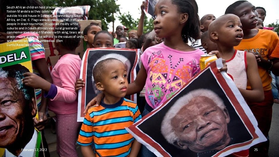 South African children hold placards showing the face of Nelson Mandela as they celebrate