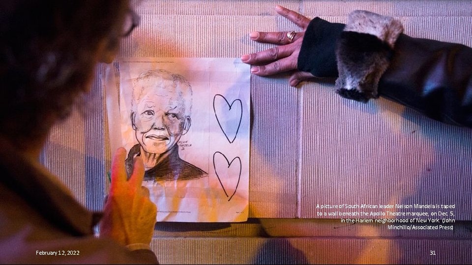 A picture of South African leader Nelson Mandela is taped to a wall beneath