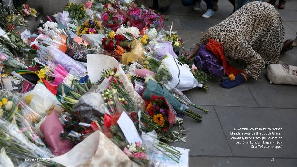 A woman pays tribute to Nelson Mandela outside the South African embassy near Trafalgar