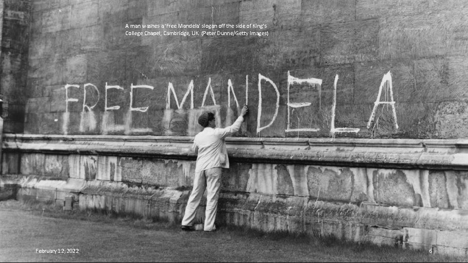 A man washes a 'Free Mandela' slogan off the side of King's College Chapel,