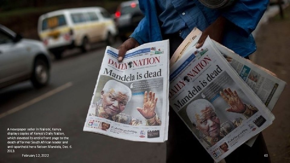 A newspaper seller in Nairobi, Kenya displays copies of Kenya's Daily Nation, which devoted