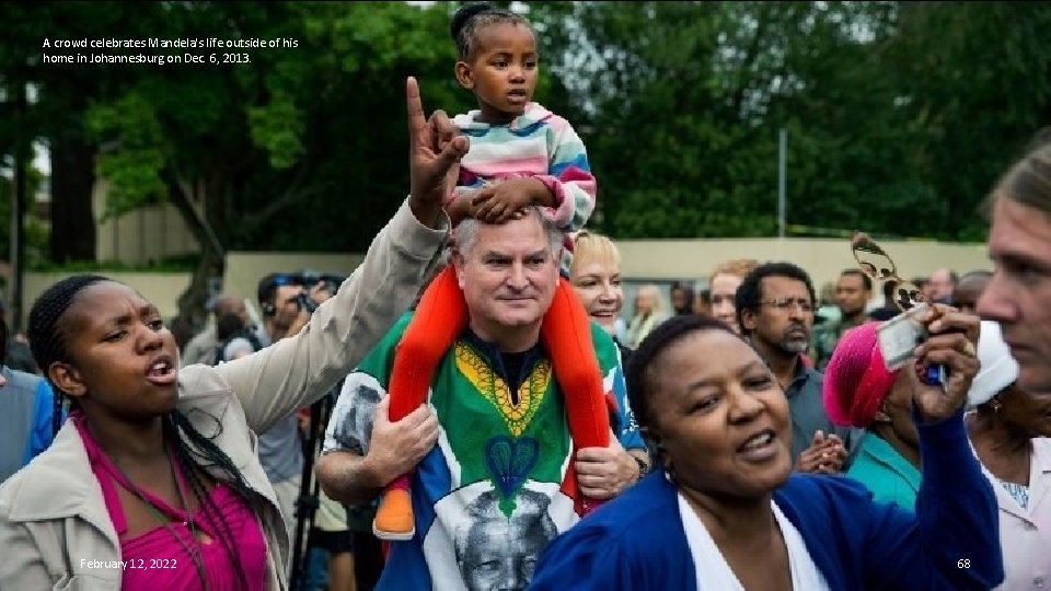 A crowd celebrates Mandela's life outside of his home in Johannesburg on Dec. 6,