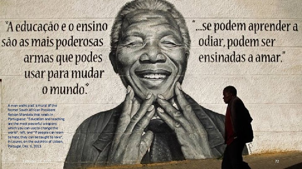 A man walks past a mural of the former South African President Nelson Mandela