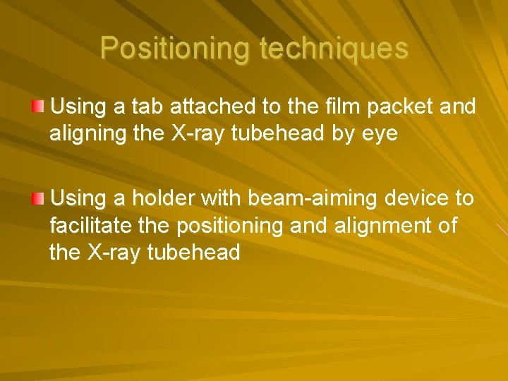 Positioning techniques Using a tab attached to the film packet and aligning the X-ray