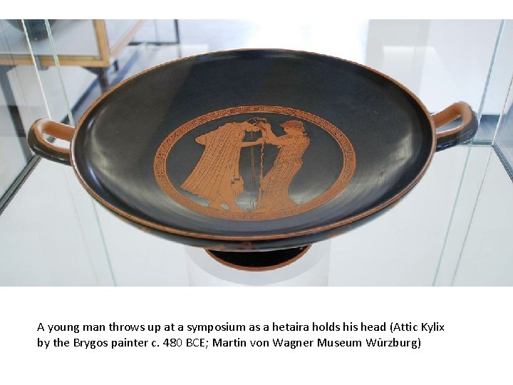 A young man throws up at a symposium as a hetaira holds his head