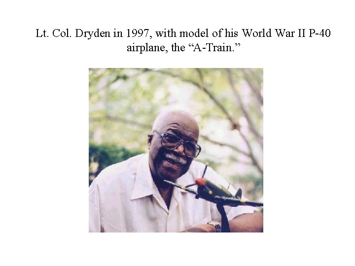 Lt. Col. Dryden in 1997, with model of his World War II P-40 airplane,