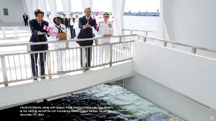 President Obama, along with Japan's Prime Minster Shinzo Abe, toss flowers at the wishing