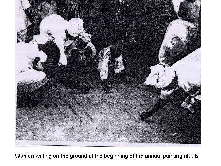 Women writing on the ground at the beginning of the annual painting rituals 