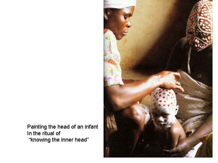 Painting the head of an infant In the ritual of “knowing the inner head”