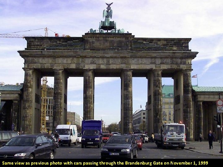 Same view as previous photo with cars passing through the Brandenburg Gate on November