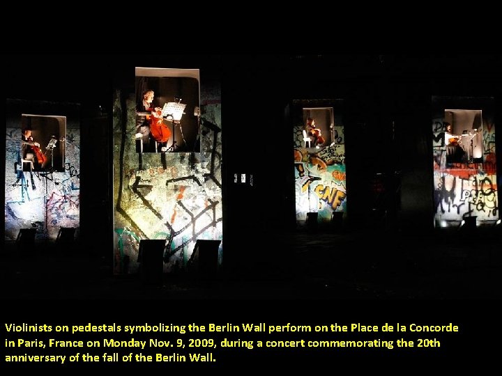 Violinists on pedestals symbolizing the Berlin Wall perform on the Place de la Concorde