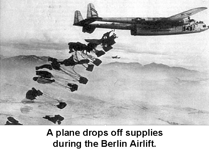 A plane drops off supplies during the Berlin Airlift. 