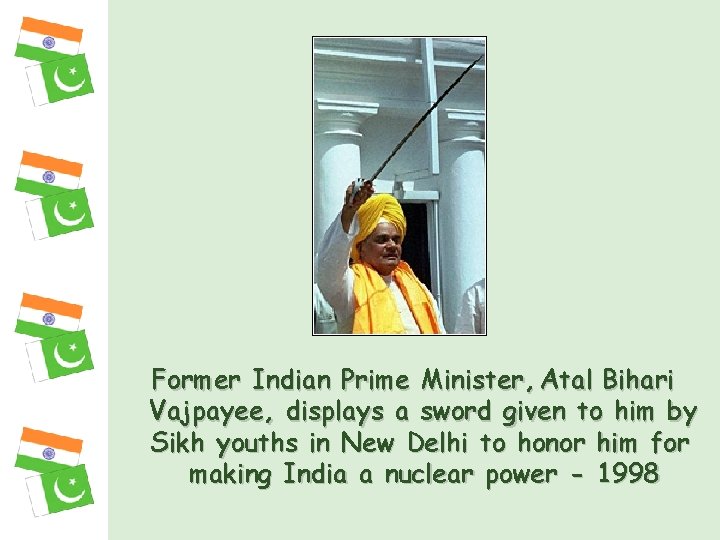 Former Indian Prime Minister, Atal Bihari Vajpayee, displays a sword given to him by