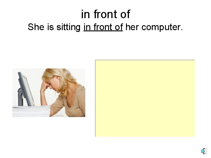in front of She is sitting in front of her computer. 