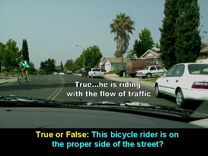 True or False: This bicycle rider is on the proper side of the street?
