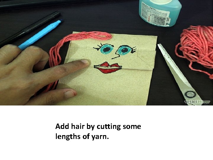 Add hair by cutting some lengths of yarn. 