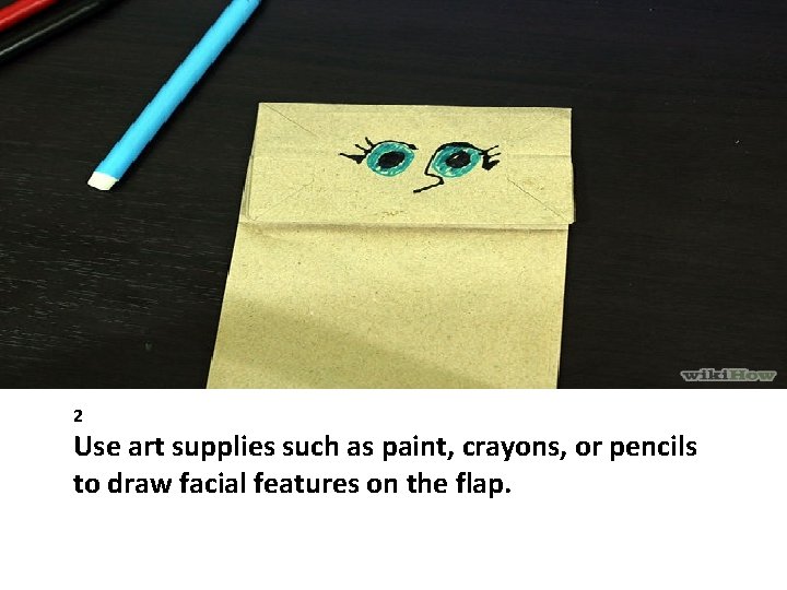 2 Use art supplies such as paint, crayons, or pencils to draw facial features