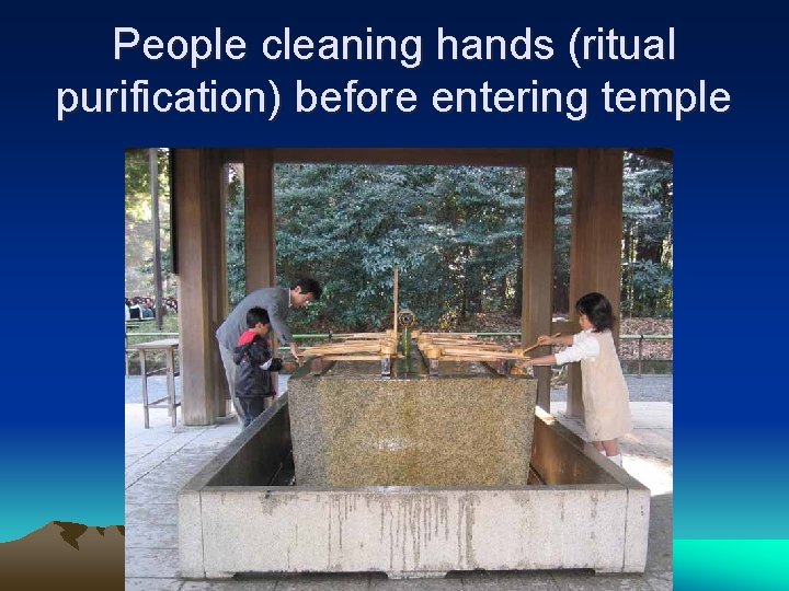 People cleaning hands (ritual purification) before entering temple 