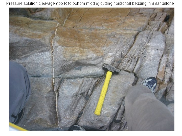 Pressure solution cleavage (top R to bottom middle) cutting horizontal bedding in a sandstone