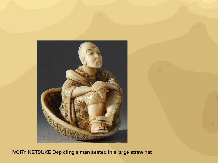 IVORY NETSUKE Depicting a man seated in a large straw hat 