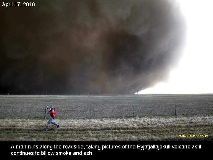 April 17, 2010 Photo: Halldor Kolbeins A man runs along the roadside, taking pictures