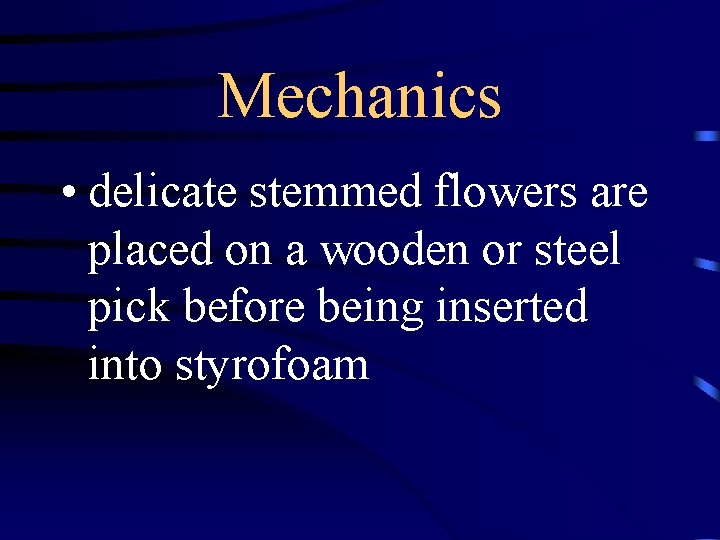 Mechanics • delicate stemmed flowers are placed on a wooden or steel pick before