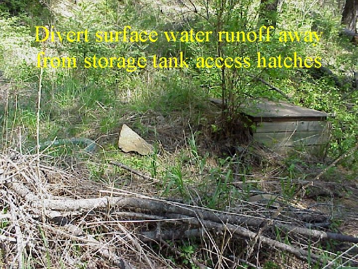 Divert surface water runoff away from storage tank access hatches 