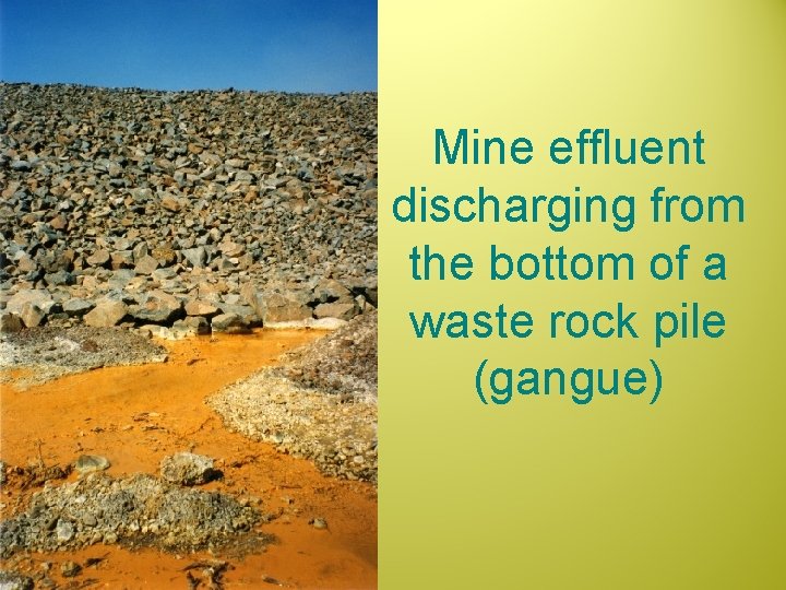 Mine effluent discharging from the bottom of a waste rock pile (gangue) 