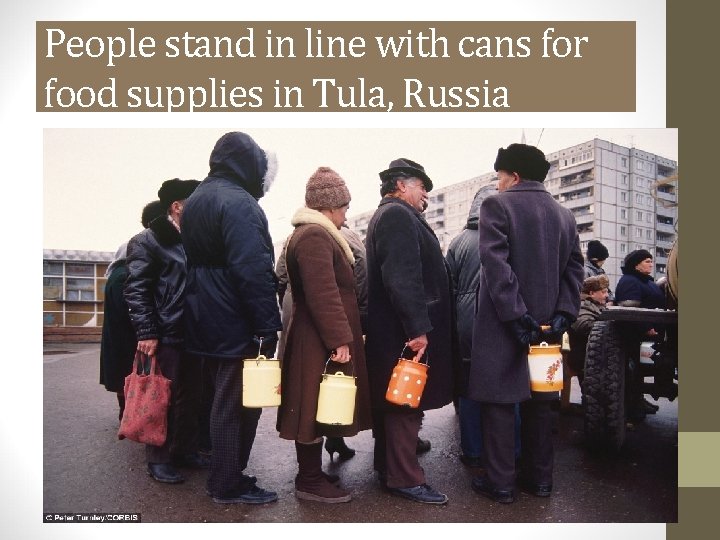 People stand in line with cans for food supplies in Tula, Russia 