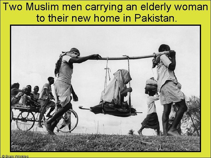 Two Muslim men carrying an elderly woman to their new home in Pakistan. ©