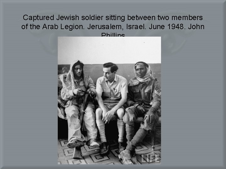 Captured Jewish soldier sitting between two members of the Arab Legion. Jerusalem, Israel. June