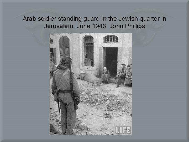 Arab soldier standing guard in the Jewish quarter in Jerusalem. June 1948. John Phillips